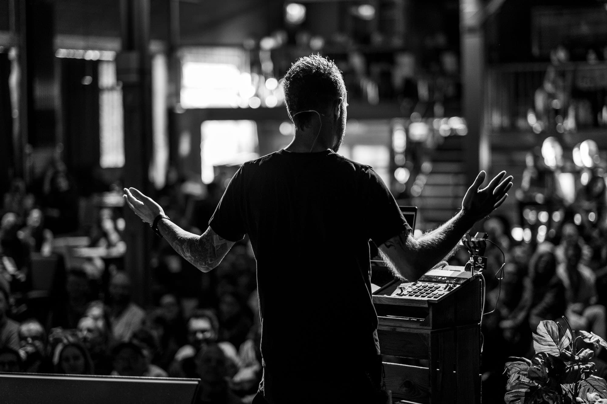 Photo from behind, in black and white, me speaking to the crowd